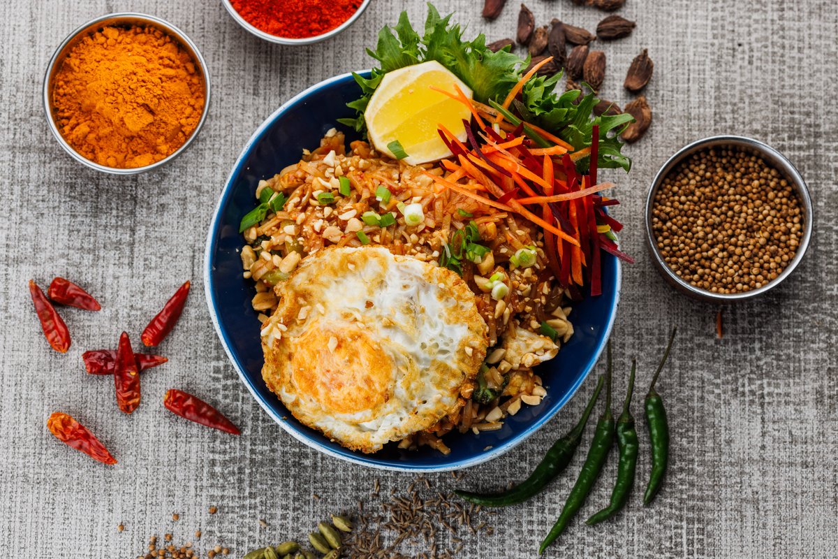 Pad Thai chicken noodles – very popular street food from thai land with fresh vegetable...