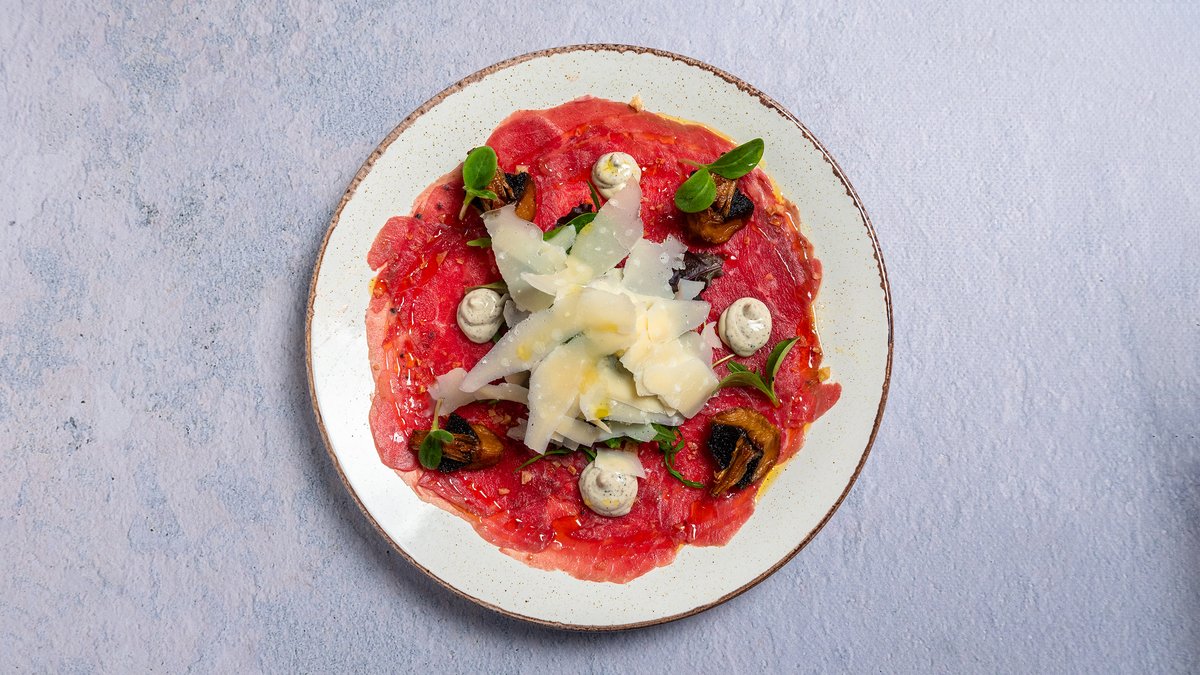 Carpaccio Iumentis – Arugula, champignon mushrooms, parmigiano, truffle oil