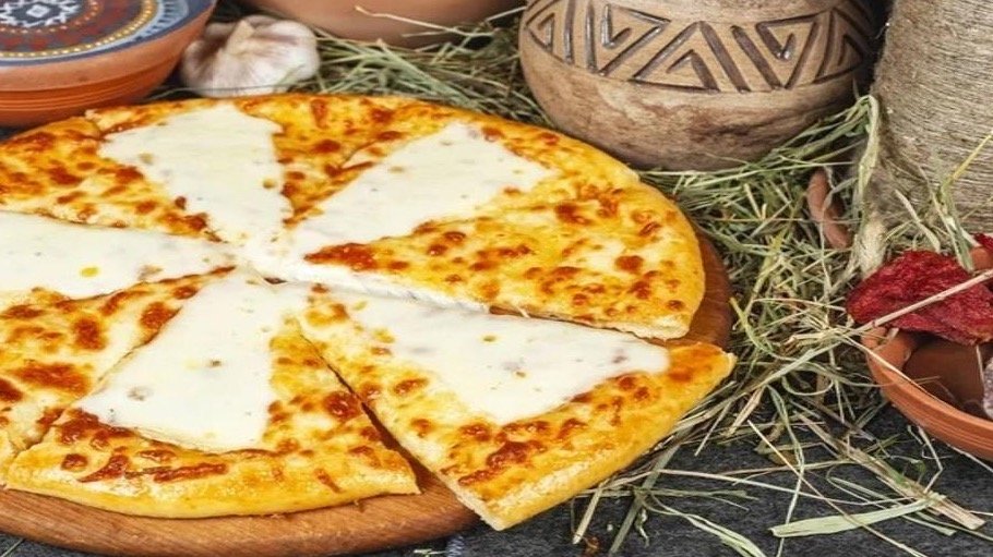 Khachapuri Tavaduri – Traditional Georgian baked bread filled with rich melted che...